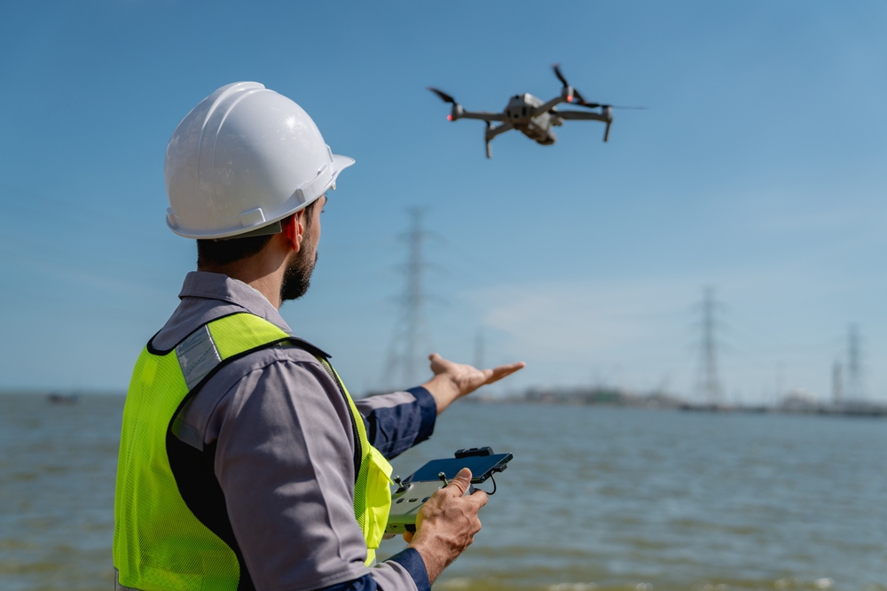 Engineer,In,A,Safety,Vest,Operating,A,Drone,To,Inspect